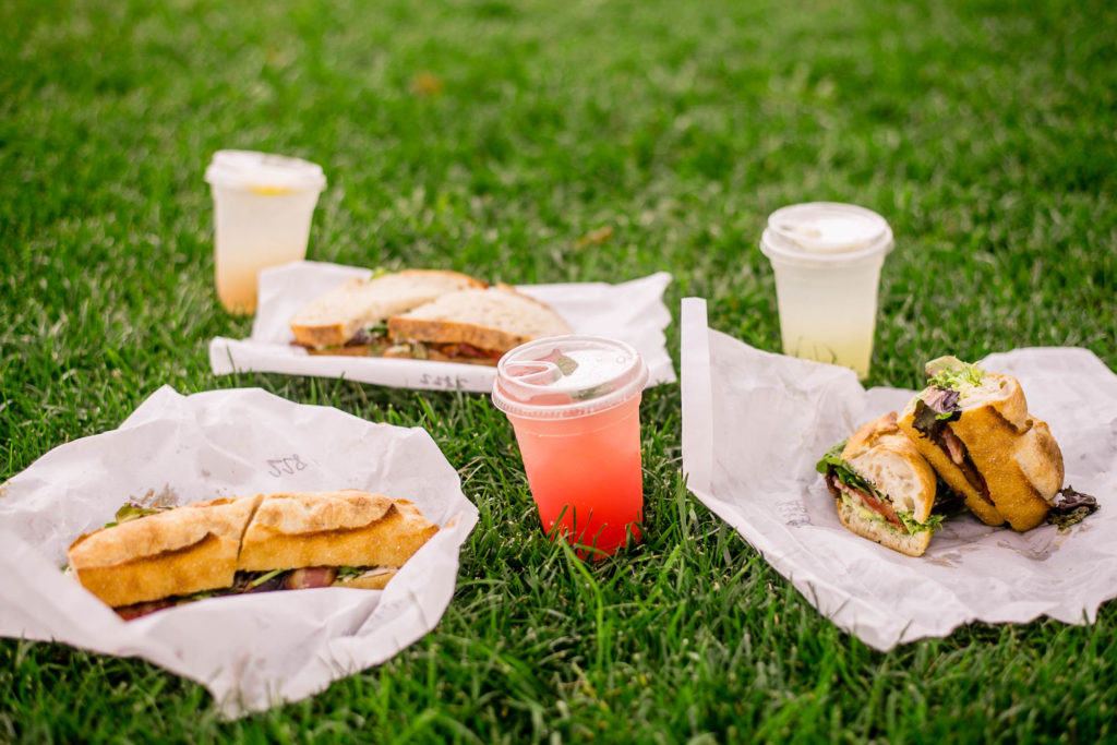 Sandwiches and drinks on the grass outside of Forge Baking Company