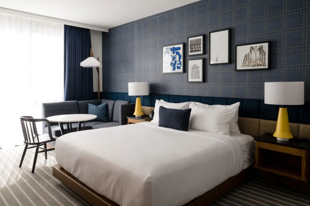 Sofa and a bed in a room at Cambria's hotel in Somerville, MA