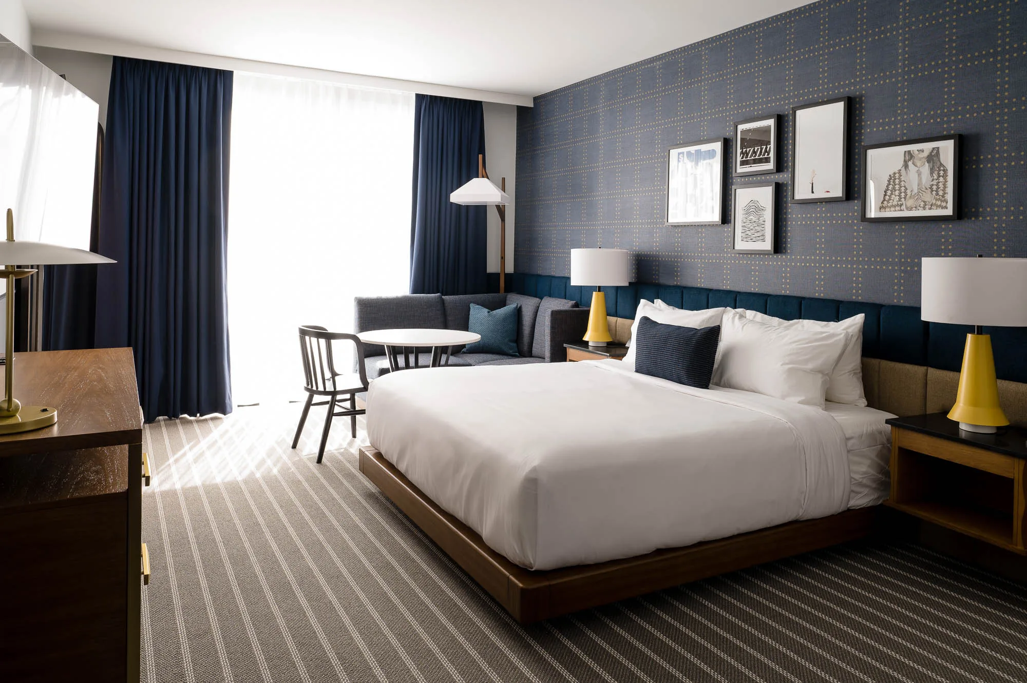 Medford-Somerville hotel room with a bed, large windows, and seating