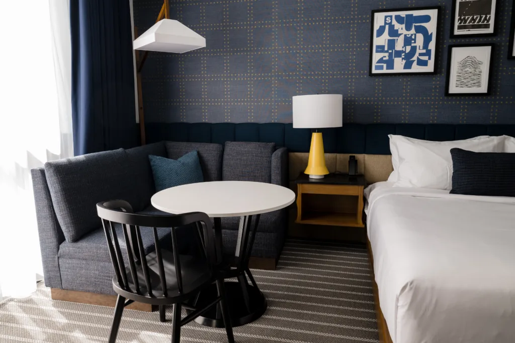 Sofa, sitting table, bed, and an end table at our hotel in Somerville, MA