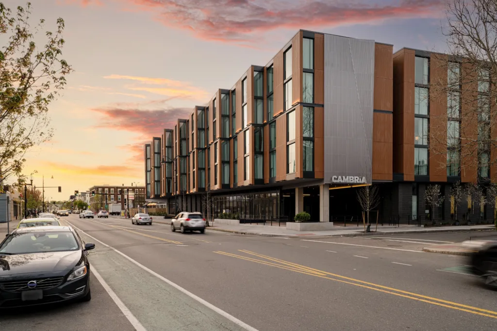 Sunset and exterior of Cambria Somerville hotel in Somerville, MA
