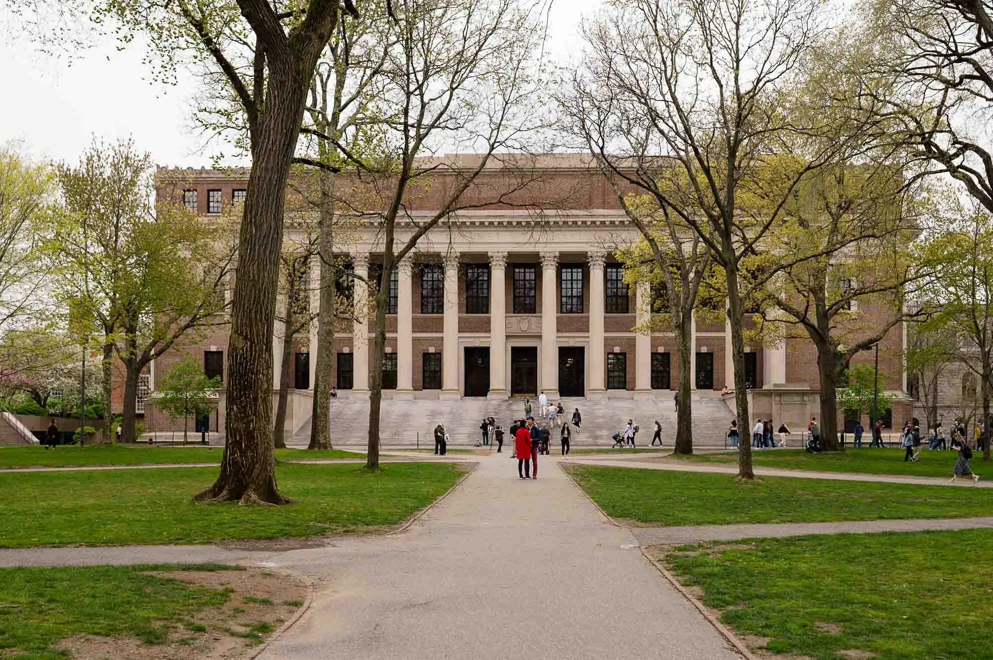 Students lounging outside of a building at Harvard University