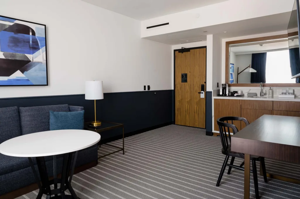 Sink and seating area in a room at Cambria hotel in Boston-Somerville