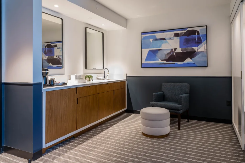 Food prep area and a lounge chair in a Somerville, Mass. hotel room