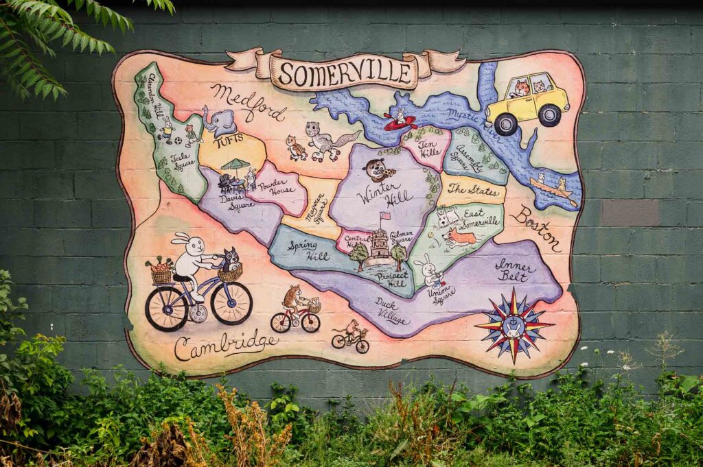 Mural with a map of Somerville, MA and cartoon illustrations