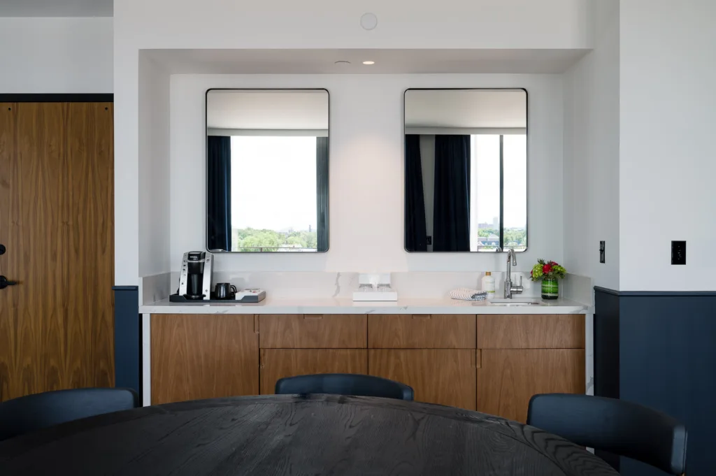 Two mirrors over a room's food prep area at a Cambria Somerville in MA