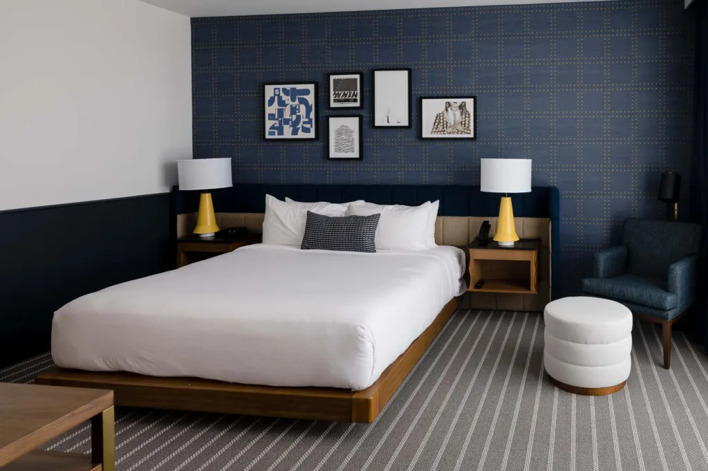 Room at our Medford-Somerville hotel with a large bed and twin lamps