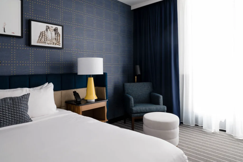 Bed, seating, and a large window in a room at our Somerville hotel