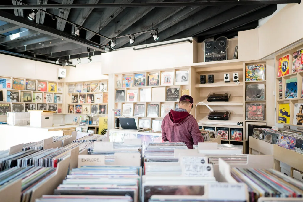 Display shelves and boxes of vinyls at a record store in Somerville, MA