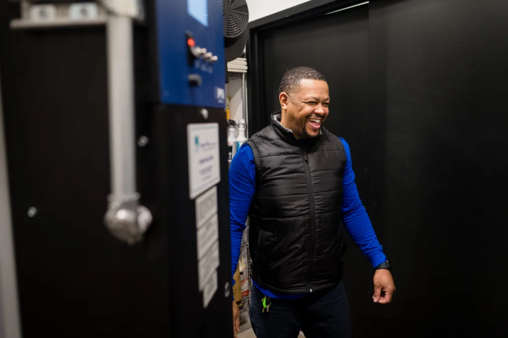Man laughing in a back room at Cambria in Somerville-Boston