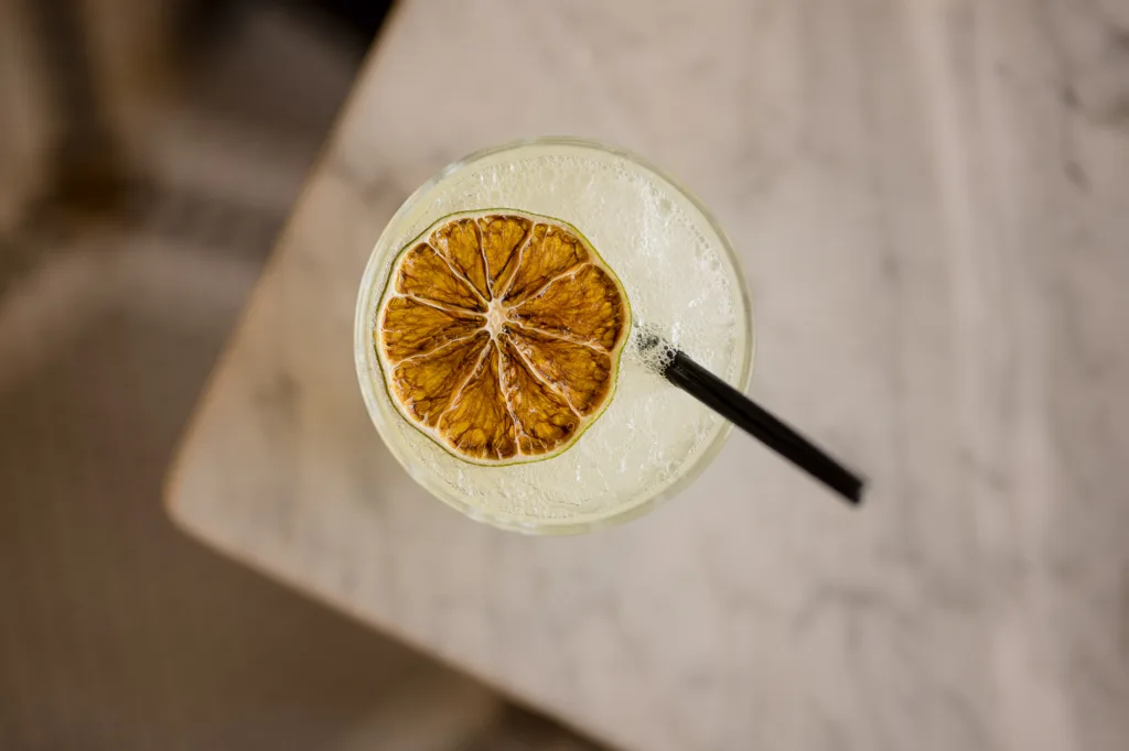 Cocktail garnished with a dried citrus wheel at Cambria Hotel Boston-Somerville