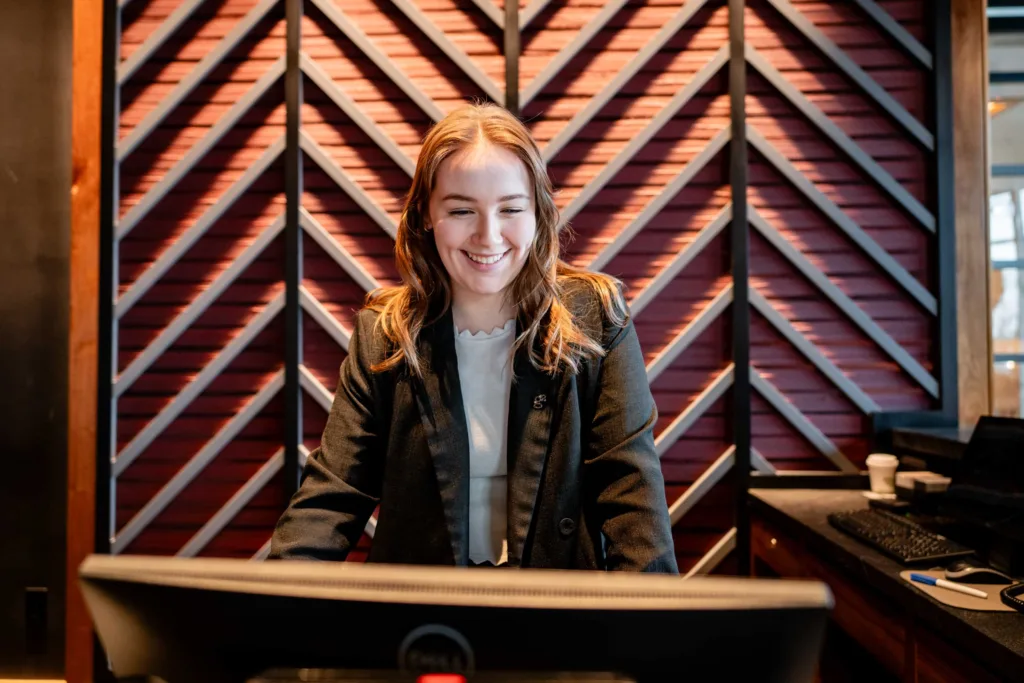 Front desk staff working at a computer at Cambria Hotel Boston-Somerville