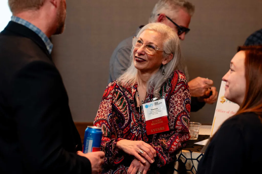 Guests conversing at a gathering at Cambria Hotel Boston-Somerville