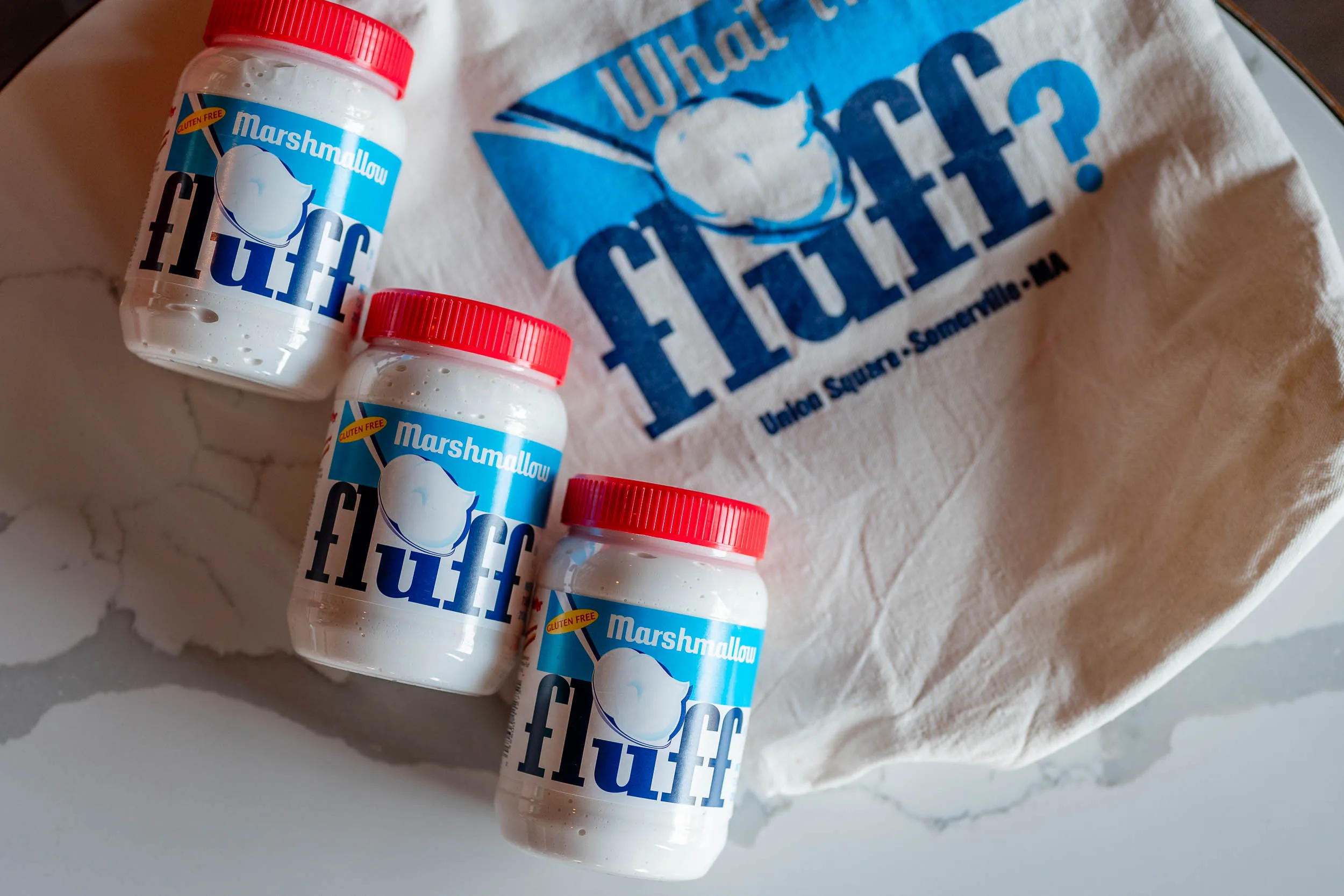 marshmallow fluff jars and a tote bag reading what the fluff union square somerville ma